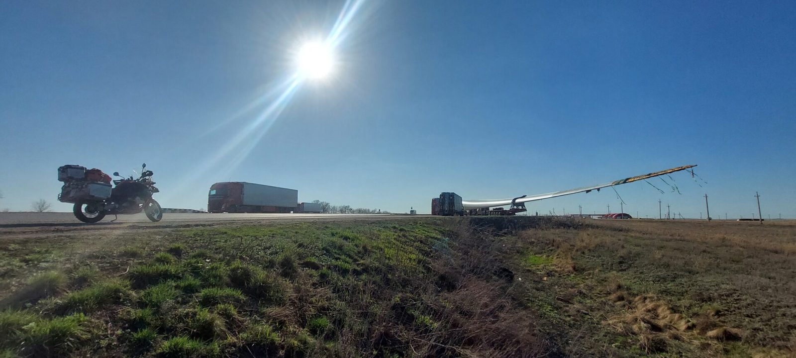 Kazakhstan, 7 April 2026: a wind-turbine blade on a low-loader, and the GS waiting its turn